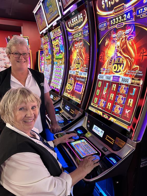 Photo of two ladies at slot machines 