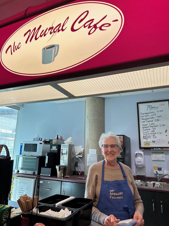 Photo of an Auxiliary volunteer working at the Mural Cafe 